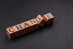 The inscription chance or change with wooden cubes on a dark concrete background photo