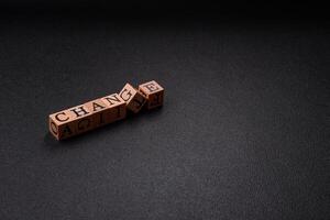 The inscription chance or change with wooden cubes on a dark concrete background photo
