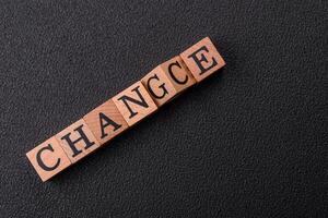 The inscription chance or change with wooden cubes on a dark concrete background photo