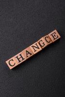 The inscription chance or change with wooden cubes on a dark concrete background photo