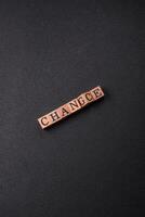 The inscription chance or change with wooden cubes on a dark concrete background photo