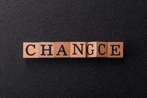 The inscription chance or change with wooden cubes on a dark concrete background photo
