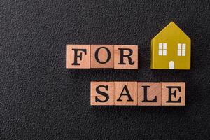 The inscription for sale laid out with wooden cubes photo