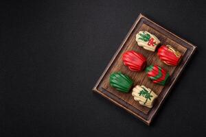 Sweet madeleine sponge cookies covered with colored chocolate photo