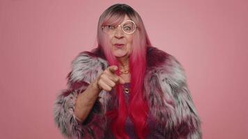 Woman pointing to camera and looking with playful happy expression, making choice, showing direction video