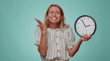Confused woman with anxiety checking time on clock, running late to work, being in delay, deadline video