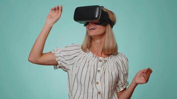 Woman using virtual reality futuristic technology VR headset helmet to play simulation 3D game video