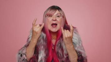 Overjoyed happy woman showing rock n roll gesture by hands, cool sign, shouting yeah with crazy face video