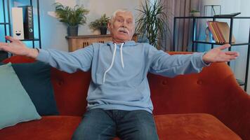 Senior man asking why, what reason of failure, demonstrating disbelief irritation by troubles video