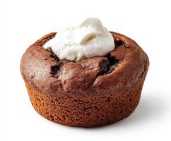 Chocolate muffin topped with whipped cream in a bright setting photo