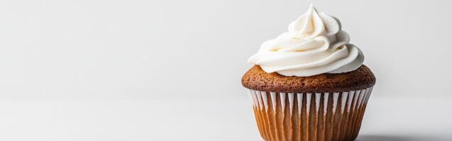 Deliciously frosted cupcake on a simple white background photo