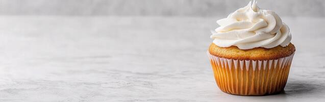Delicious vanilla cupcake with frosting on light background photo