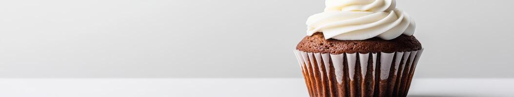 Delicious chocolate cupcake with creamy frosting on display photo