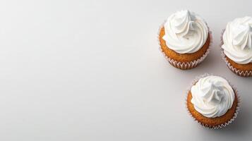 Delicious cupcakes with creamy frosting on a light background photo