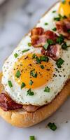 Delicious breakfast sandwich with sunny side up eggs and bacon photo