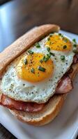 Delicious breakfast sandwich with fried eggs and bacon served on bread photo
