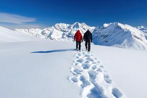 Winter hikers explore snowy mountain trails under blue skies photo