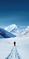Hiking through snow-covered valley towards majestic mountain photo