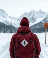 Person hiking through snow-covered mountain landscape photo