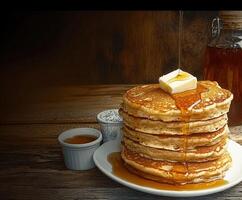 Delicious stack of pancakes with syrup and butter served photo