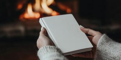 Cozy evening by the fire with a blank notebook in hand photo