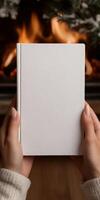Cozy evening by the fireplace with a blank notebook photo
