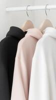 Stylish collection of coats displayed on hangers indoors photo