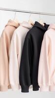 Stylish hoodies hanging in a modern clothing display photo