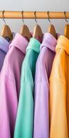 Colorful hoodies hanging neatly on a wooden rack photo