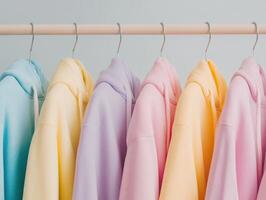Colorful hoodies hanging on a rack in a stylish setting photo