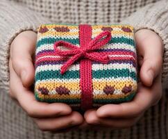 Gift wrapped in colorful knit fabric held with care photo