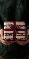 Gift wrapped in cozy knit pattern held by person indoors photo