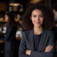Confident woman in business attire at a modern cafe setting photo