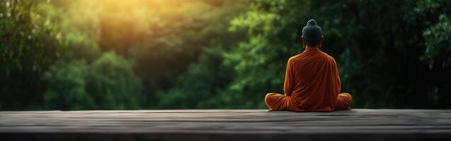 Monk meditating in serene nature at sunrise photo