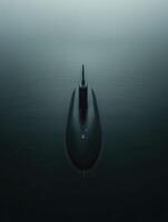 Submarine navigating through calm, mist-covered waters photo