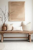 Stylish bathroom bench with decorative pillows and art photo