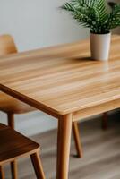 Cozy wooden dining table with plant in a modern setting photo