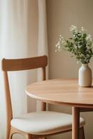 Simple interior with floral arrangement on wooden table photo