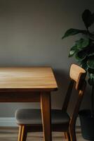 Minimalist dining area with wooden table and plant photo