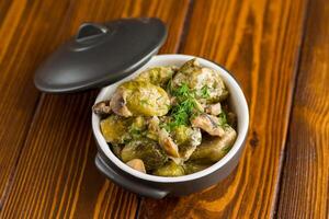 Brussel sprouts stewed in sour cream sauce with mushrooms and spices photo