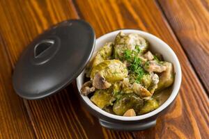 Brussel sprouts stewed in sour cream sauce with mushrooms and spices photo