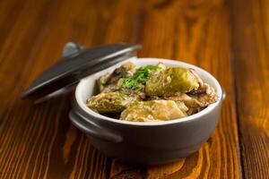 Brussel sprouts stewed in sour cream sauce with mushrooms and spices photo