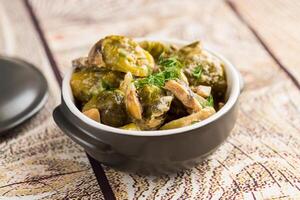 Brussel sprouts stewed in sour cream sauce with mushrooms and spices photo