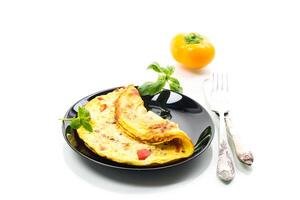 fried omelette with sweet pepper and vegetables in a plate, isolated on white background photo