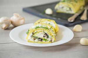 baked potato roll with cottage cheese filling with garlic and mushrooms, on a light wooden table photo