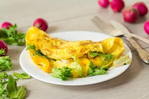 egg roll with sweet pepper and salad, on a wooden table photo