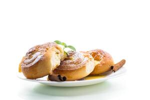 Baked goods. Sweet buns with cottage cheese filling and honey in a plate isolated on a white background photo