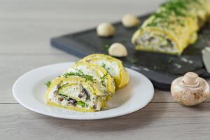 baked potato roll with cottage cheese filling with garlic and mushrooms, on a light wooden table photo