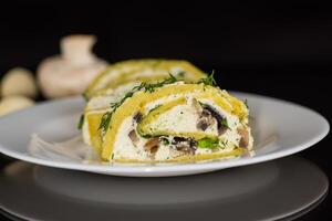 baked potato roll with cottage cheese filling with garlic and mushrooms, isolated on black background photo