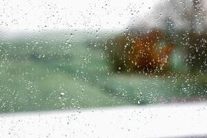 Drops on a window with a beautiful background photo